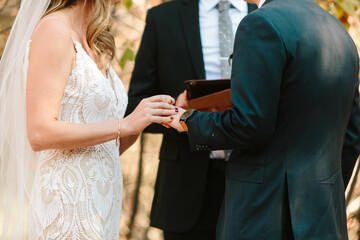 caucasian couple on wedding day outdoor in suit and white dress