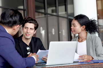 Businesspeople meeting together at office workplace. Business partnership and colleague coworker discussing and brainstorming for new project work. Business officer offering new products to customer