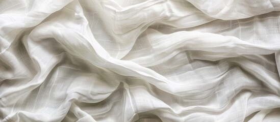 Obraz premium Top view of a white crumpled linen fabric texture background resembling natural organic eco textiles with a canvas like quality displaying ample copy space image