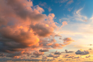 Small clouds in dramatic real sky at sunset texture background overlay.