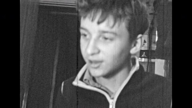 Archival film, teenager portrait nodding head, agreement, saying yes. Young man agreeing, approval idea in Soviet interior. Male face expression of agree, approve. Retro black white archive. 1980s