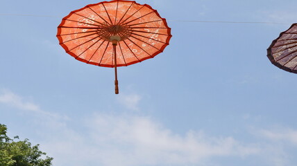 traditional wooden umbrella hanging against the sky background