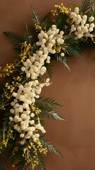 Mimosa fresh flowers frame on earth tones brown background
