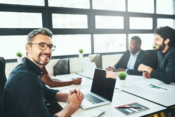 Portrait, businessman and laptop in office in coworking in digital agency as brand designer. Male person, smile and technology as colleagues for teamwork, collaboration and deadline with mockup space