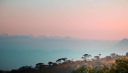 Mountain sunrise paints the sky with vibrant colors as golden light bathes the peaks