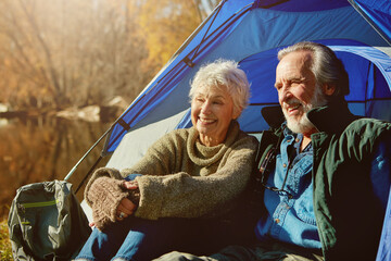 Old couple, tent and camping with nature, sunshine and vacation with hobby, retirement and field. Outdoor, senior man or mature woman with holiday, getaway trip or relax with weekend break and love