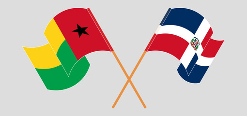 Crossed and waving flags of Guinea-Bissau and Dominican Republic