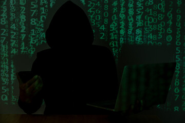 A man in black is hacking personal computer data, representing the concept of cybersecurity.