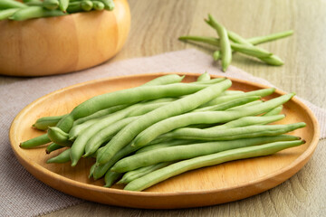 Common bean,Bush beans are french green beans in wooden plate.