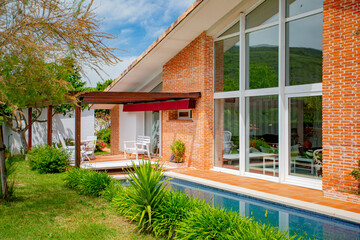 Pool area of a country house with lilac plants in foreground