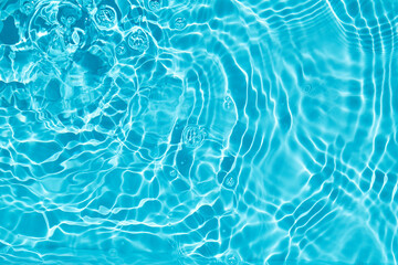 Rippling Water Surface. A calming image of rippling blue water with light reflections.