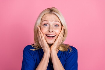 Photo portrait of attractive retired woman touch cheeks amazed dressed stylish blue clothes isolated on pink color background