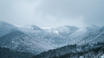Wide shot of a mountain range in winter. 