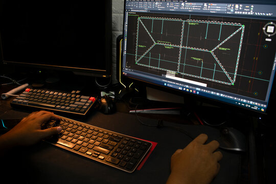 Architect Engineer Design 2D displaying a model of a complex architectural project. Designer or architect working on a laptop.