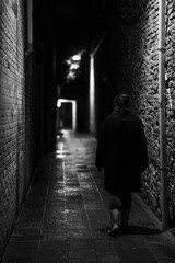 Woman crossing a dark street