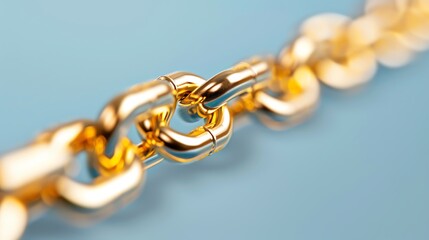 Fototapeta premium A close-up image of a gold chain on a blue background.