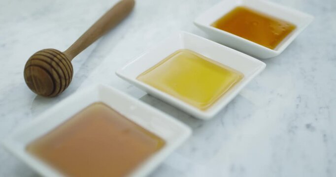 Three honey palates with honey stick pull out shot