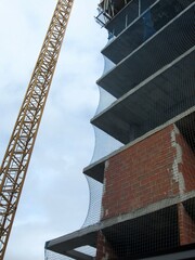 construction site with crane and netting