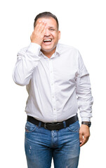 Middle age arab elegant man over isolated background covering one eye with hand with confident smile on face and surprise emotion.