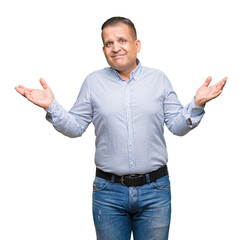 Middle age arab business man over isolated background clueless and confused expression with arms...
