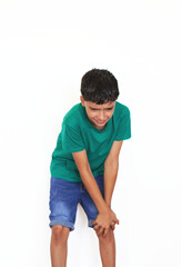 child with a gesture of suffering and pain, bringing his hands to his knee.