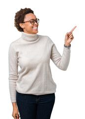 Young beautiful african american woman wearing glasses over isolated background with a big smile on face, pointing with hand and finger to the side looking at the camera.