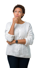 Beautiful young african american woman wearing sweater over isolated background with hand on chin...