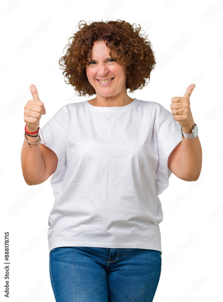 Wall mural beautiful middle ager senior woman wearing white t-shirt over isolated background doing happy thumbs