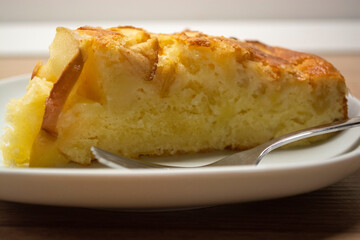 A mouthwatering slice of apple pie on a white plate. Baking apple pie