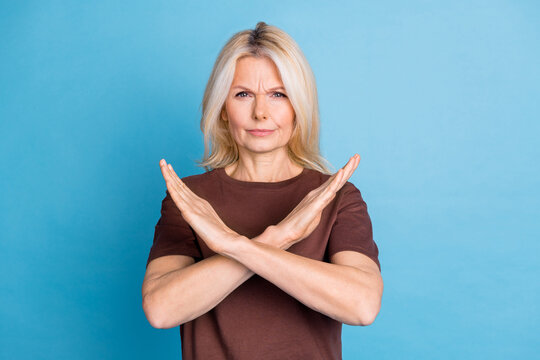 Photo of serious lovely senior woman wear stylish brown clothes isolated on blue color background
