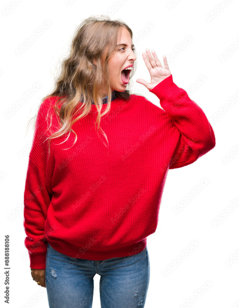 Canvas Prints Beautiful young blonde woman wearing winter sweater over isolated background shouting and screaming loud to side with hand on mouth. Communication concept.