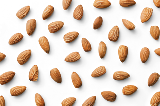 Almonds are scattered in a patter on a white background