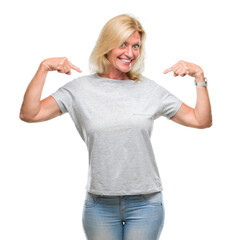 Middle age blonde woman over isolated background looking confident with smile on face, pointing oneself with fingers proud and happy.