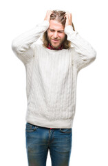 Young handsome man with long hair wearing winter sweater over isolated background suffering from headache desperate and stressed because pain and migraine. Hands on head.