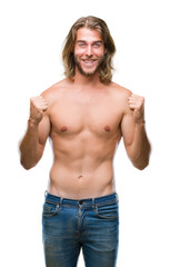 Young handsome shirtless man with long hair showing sexy body over isolated background celebrating surprised and amazed for success with arms raised and open eyes. Winner concept.