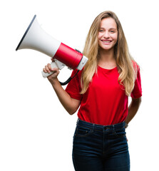 Young beautiful blonde woman yelling through megaphone over isolated background with a happy face...