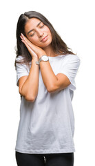 Young beautiful arab woman over isolated background sleeping tired dreaming and posing with hands together while smiling with closed eyes.