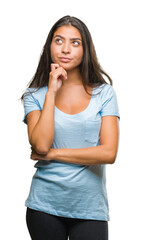 Fototapeta premium Young beautiful arab woman over isolated background with hand on chin thinking about question, pensive expression. Smiling with thoughtful face. Doubt concept.