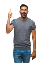 Adult hispanic man over isolated background pointing finger up with successful idea. Exited and...