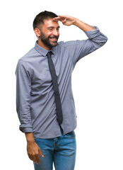 Adult hispanic business man over isolated background very happy and smiling looking far away with hand over head. Searching concept.