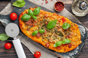 Homemade pizza with tomatoes, mozzarella and basil. Top view