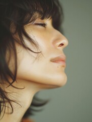Fototapeta premium Artist and musician. Close up of a serene young woman with closed eyes, enjoying a moment of tranquility