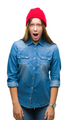 Young caucasian beautiful woman wearing wool cap over isolated background afraid and shocked with surprise expression, fear and excited face.