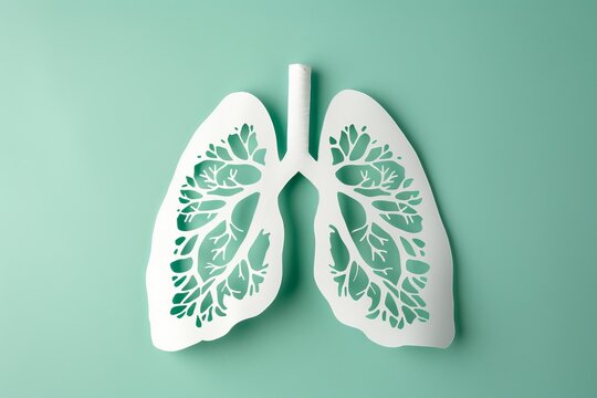 Paper lungs with intricate design on teal background representing respiratory health concept