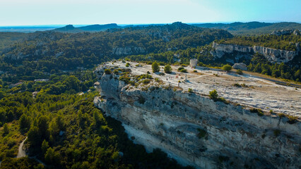 Aerial view of a French village perched in the mountains. Rock spur on which the village Baux-de-Provence is built, France. One of the best and most characteristic small rural villages in Provence. 