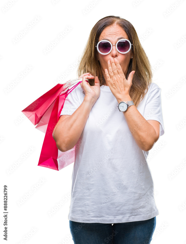 Sticker Middle age hispanic woman holding shopping bags on sales over isolated background cover mouth with hand shocked with shame for mistake, expression of fear, scared in silence, secret concept