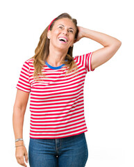 Beautiful middle age woman wearing casual stripes t-shirt over isolated background Smiling confident touching hair with hand up gesture, posing attractive