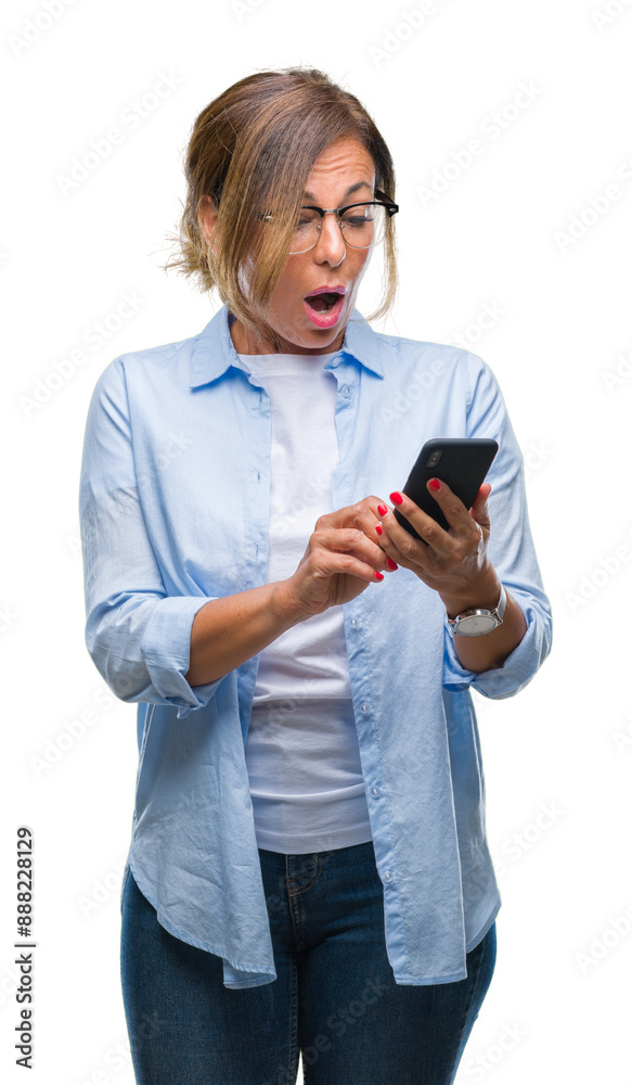 Wall mural middle age senior woman texting sending message using smartphone over isolated background scared in 