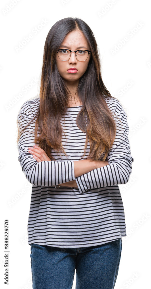 Poster young asian woman wearing glasses over isolated background skeptic and nervous, disapproving express