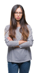 Young asian woman wearing glasses over isolated background skeptic and nervous, disapproving expression on face with crossed arms. Negative person.